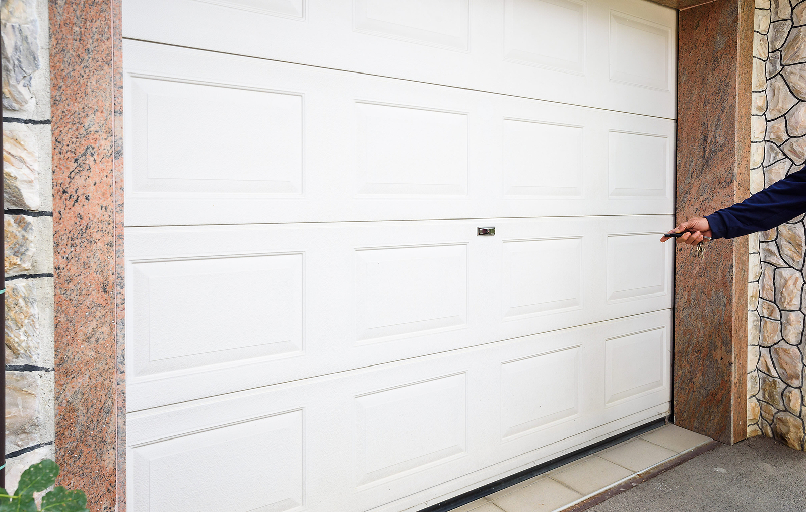 Person-Pointing-Remote-Toward-Garage-Door