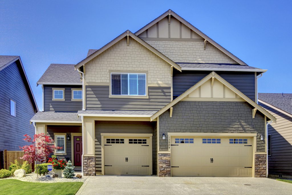 Two-Story-Suburban-Home-Light-Yellow-and-Gray-with-Two-Garage-Doors