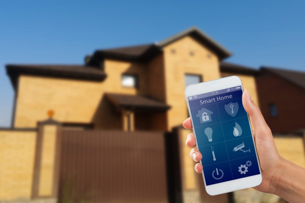 Smartphone with home security app in a hand